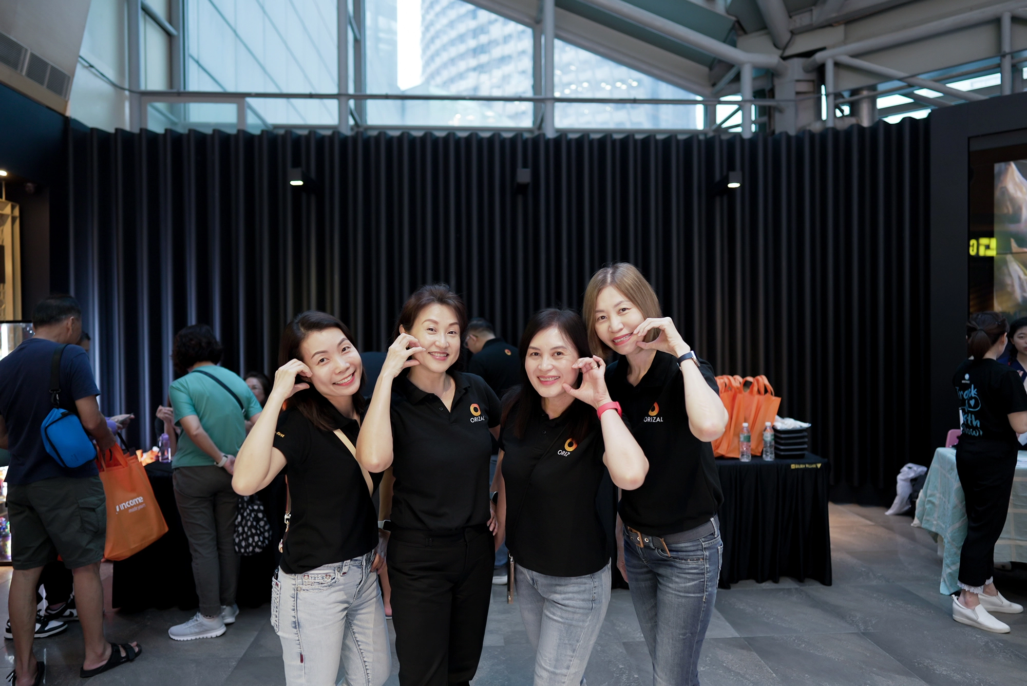 Four Orizal team members posing together at a community event