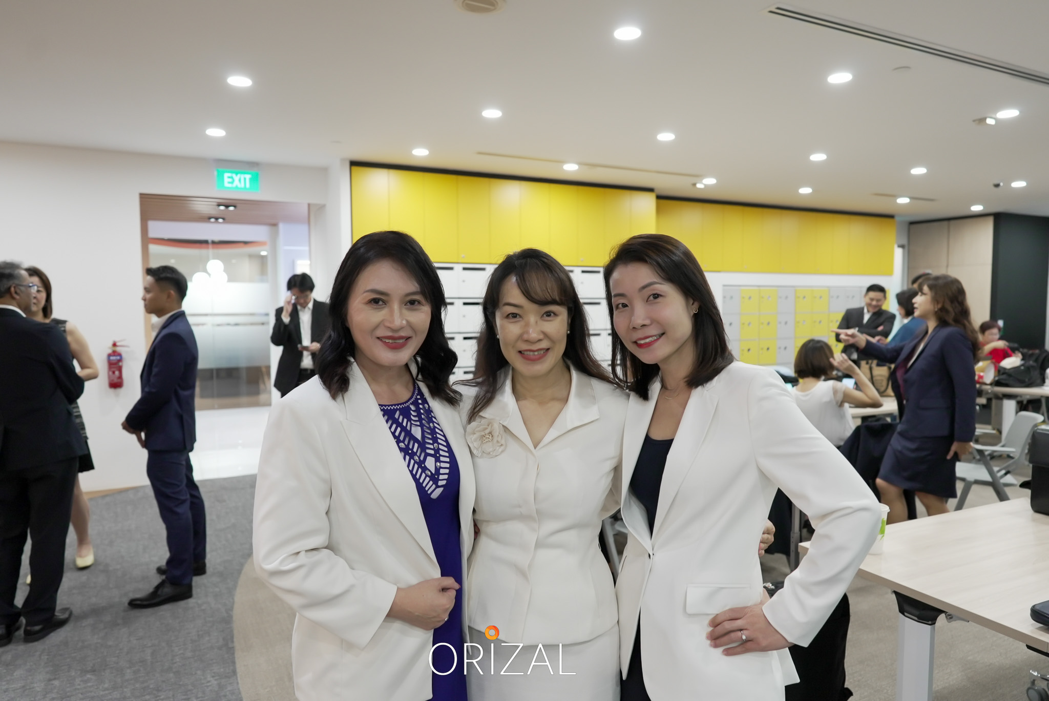 Three Orizal advisors in white blazers posing together