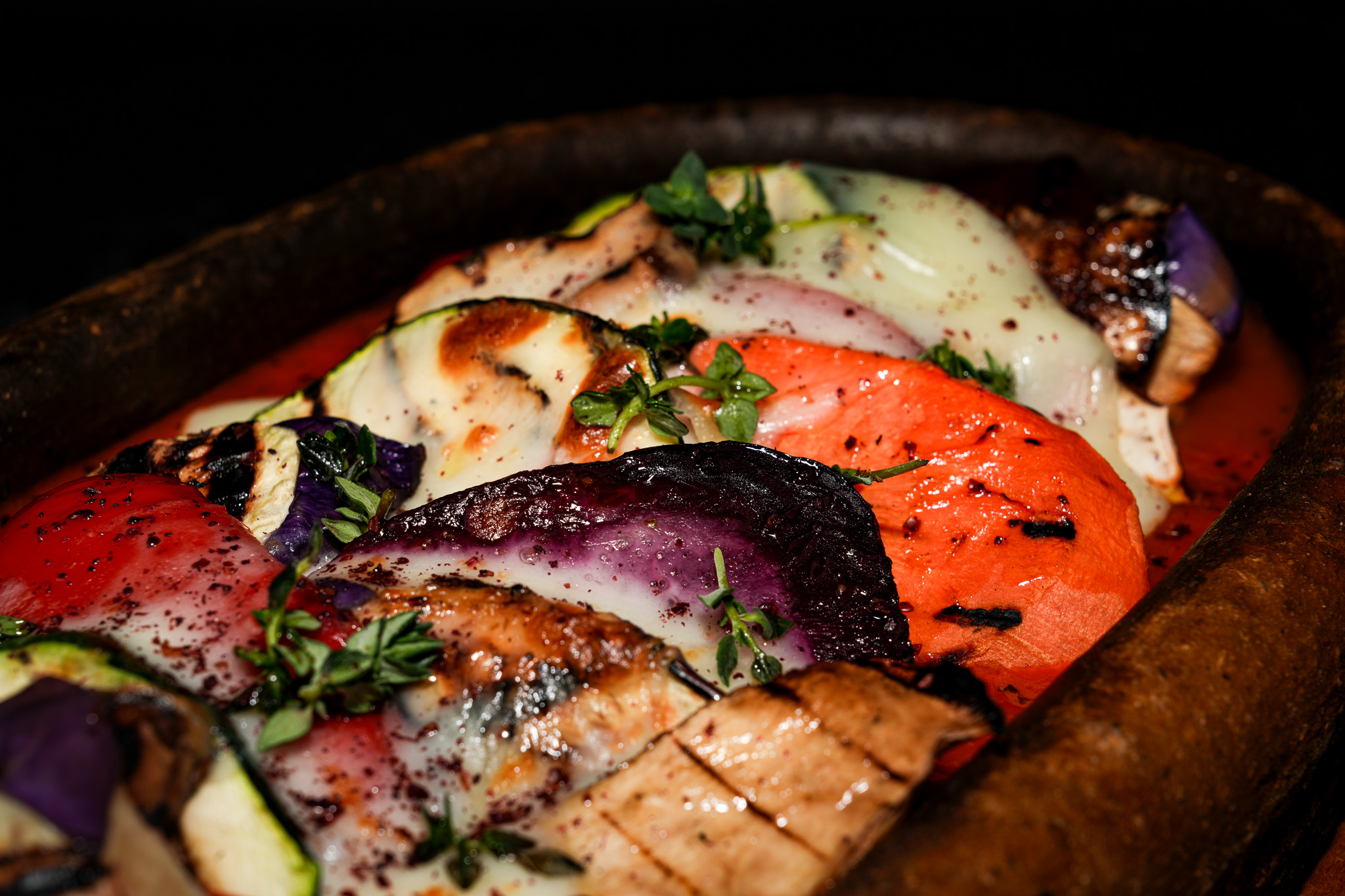 Close-up of grilled aubergine, tomato, and courgette