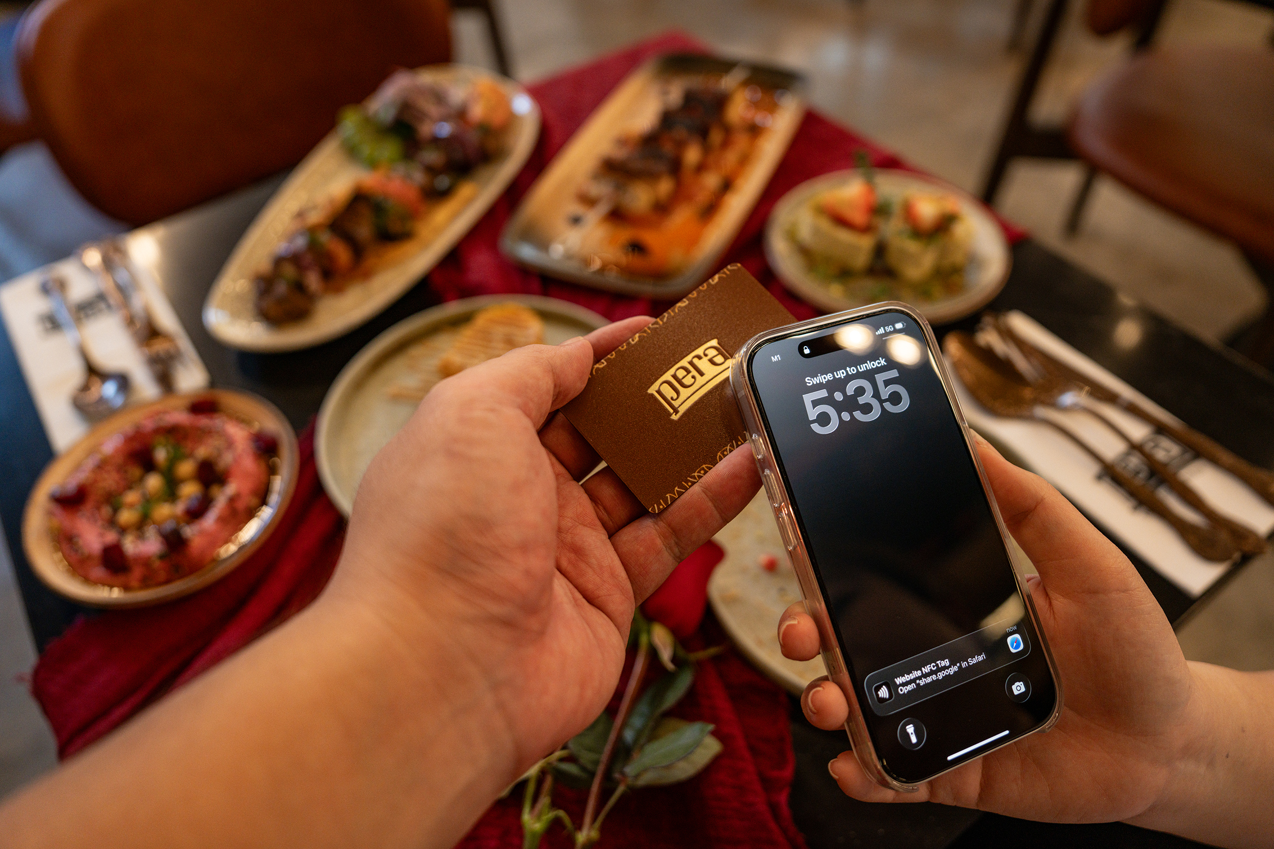 Pera NFC review card held in hand