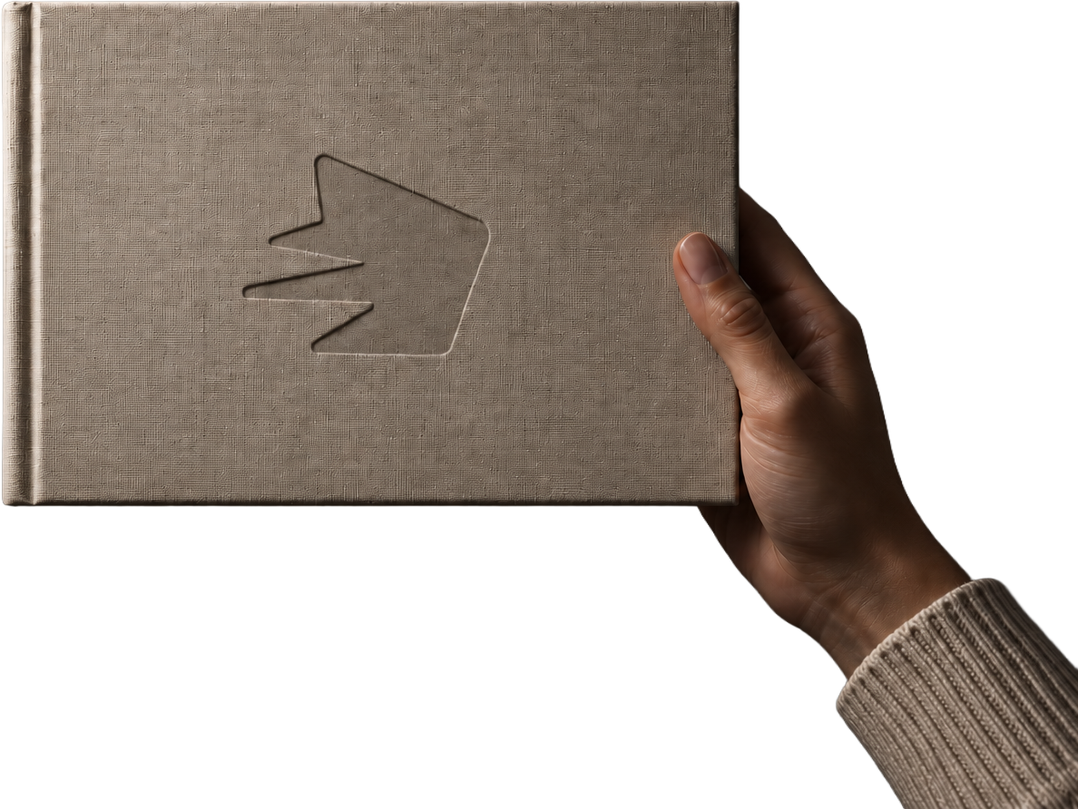 Hand holding a linen-bound book embossed with the FableForce mark